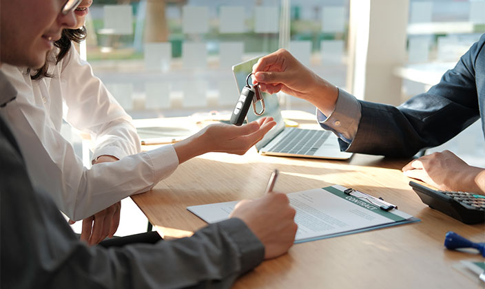 Owner gives his car key to the dealer
